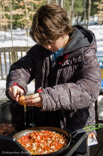 child cooking outside at Silet Lake