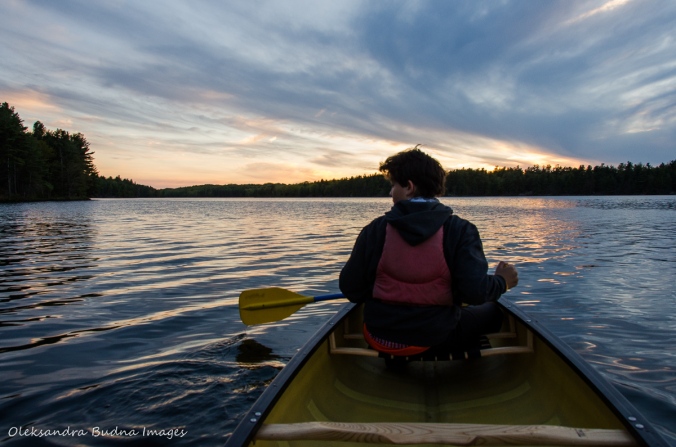 canoeing against the sunset on Big Salmon Lake in Frontenac